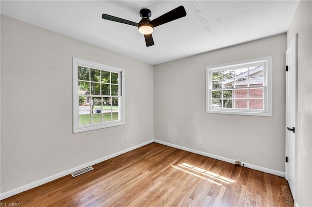 empty room featuring ceiling fan and light hardwood / wood-style floors