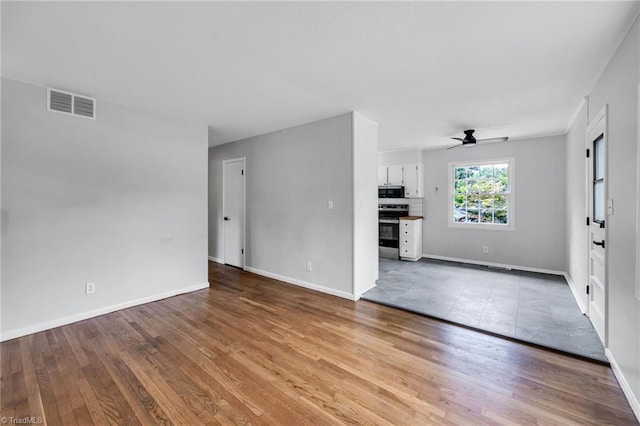 unfurnished living room with ceiling fan and light hardwood / wood-style flooring