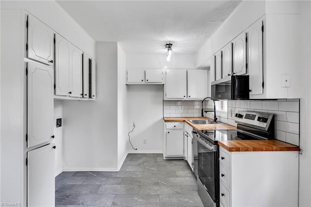 kitchen with wooden counters, tasteful backsplash, sink, white cabinetry, and stainless steel electric range