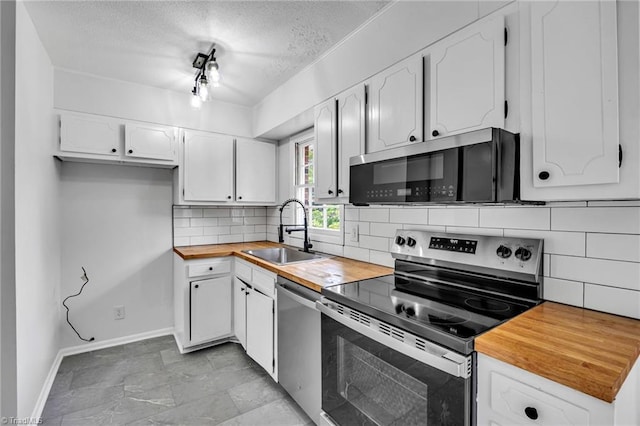 kitchen with sink, white cabinetry, stainless steel appliances, and tasteful backsplash