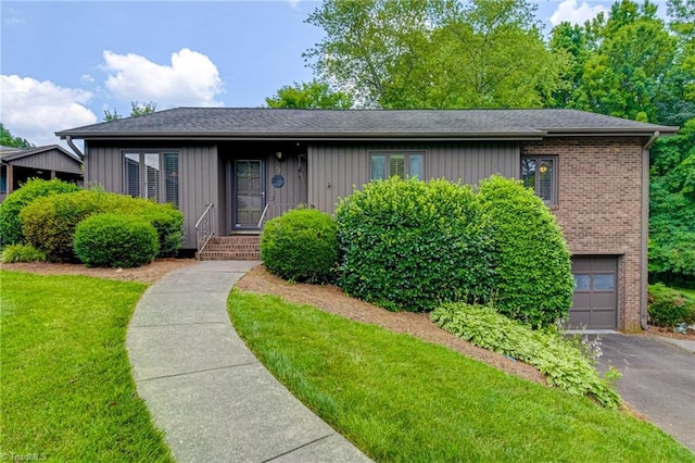 321 Bexley Dr, Winston-Salem, NC 27104 - view of front of property featuring brick siding, an attached garage, driveway, and a front yard