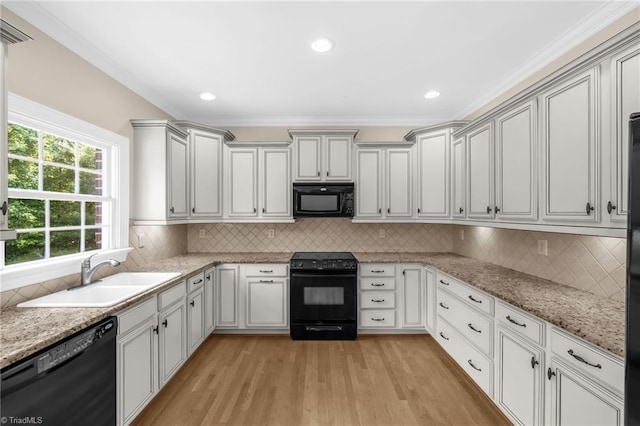 1905 Overshoot Ct, Greensboro, NC 27455 - kitchen featuring black appliances, plenty of natural light, light wood-style floors, decorative backsplash, and crown molding