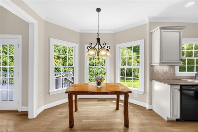 1905 Overshoot Ct, Greensboro, NC 27455 - dining space with a chandelier, light wood-style floors, healthy amount of natural light, and crown molding