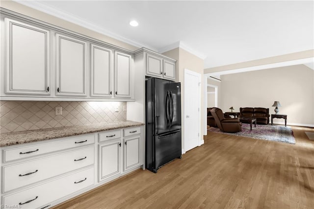 1905 Overshoot Ct, Greensboro, NC 27455 - kitchen featuring freestanding refrigerator, ornamental molding, light wood-type flooring, backsplash, and light stone countertops