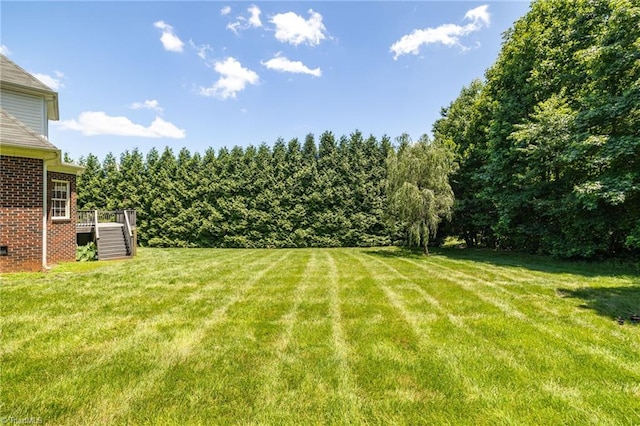 1905 Overshoot Ct, Greensboro, NC 27455 - view of grassy yard with a deck and stairs