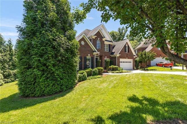 1905 Overshoot Ct, Greensboro, NC 27455 - view of front of home featuring driveway, a front yard, brick siding, and an attached garage