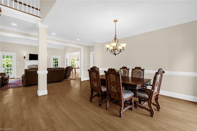 1905 Overshoot Ct, Greensboro, NC 27455 - dining room with a chandelier, wood finished floors, ornate columns, and recessed lighting