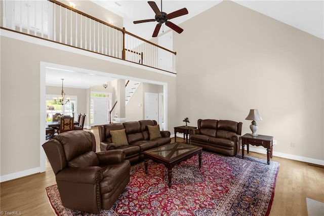 1905 Overshoot Ct, Greensboro, NC 27455 - living area with wood finished floors, ceiling fan, high vaulted ceiling, and stairway