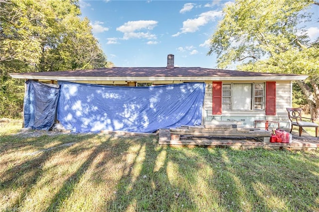 view of front of home featuring a front yard and a wooden deck