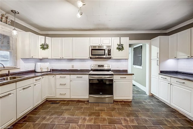 kitchen with white cabinetry, sink, hanging light fixtures, stainless steel appliances, and crown molding