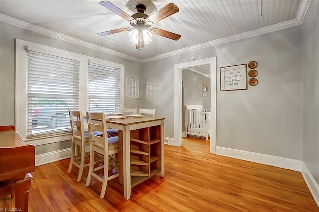 dining room with light hardwood / wood-style floors, ceiling fan, and crown molding