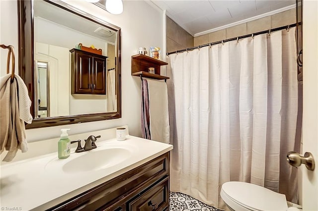 bathroom featuring toilet, vanity, and ornamental molding