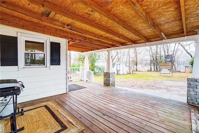 wooden terrace with a shed