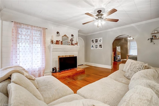 living room with ceiling fan, hardwood / wood-style floors, and ornamental molding