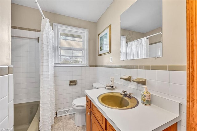 full bathroom with visible vents, toilet, tile patterned floors, vanity, and tile walls