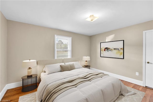 bedroom featuring baseboards and wood finished floors