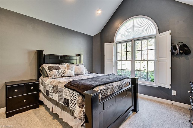 carpeted bedroom with vaulted ceiling and multiple windows