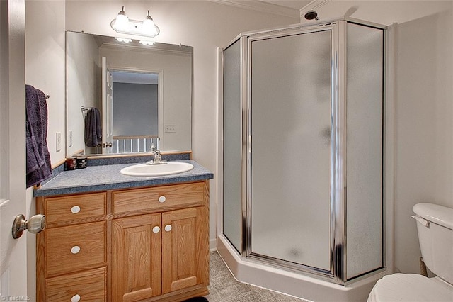 bathroom with vanity, toilet, and an enclosed shower