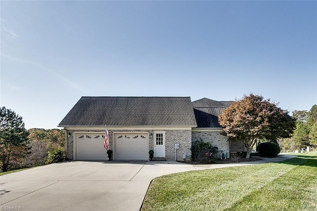 view of front facade with a front yard and a garage