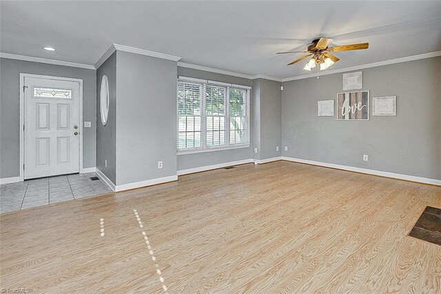 entrance foyer featuring light hardwood / wood-style flooring, ornamental molding, and ceiling fan