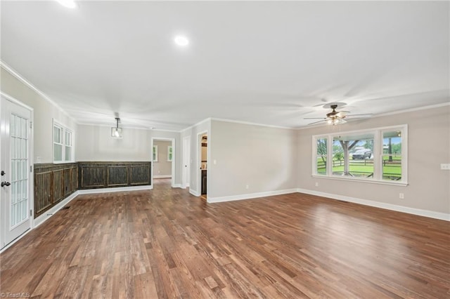 unfurnished living room with ornamental molding, wood finished floors, baseboards, ceiling fan, and recessed lighting