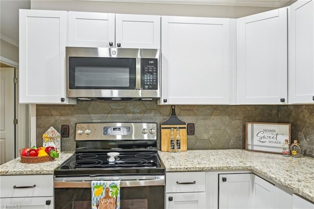 kitchen with stainless steel appliances, white cabinets, backsplash, light stone countertops, and crown molding