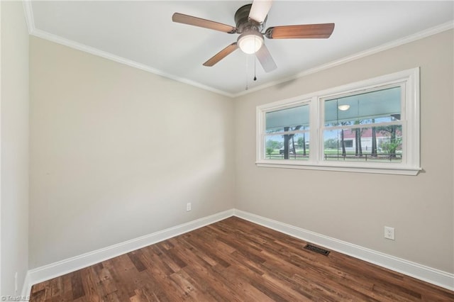 spare room with baseboards, dark wood-style floors, ornamental molding, and ceiling fan