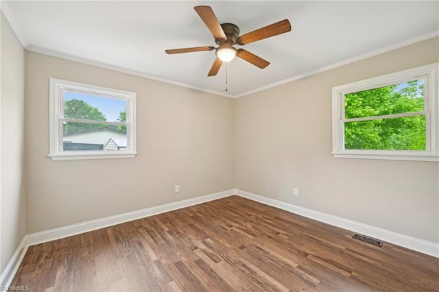 unfurnished room featuring baseboards, wood finished floors, ornamental molding, and a ceiling fan