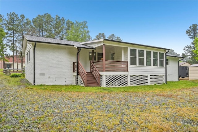 rear view of house with crawl space, stairway, and brick siding