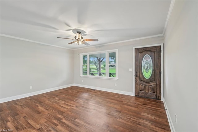 foyer entrance with ceiling fan, crown molding, baseboards, and wood finished floors