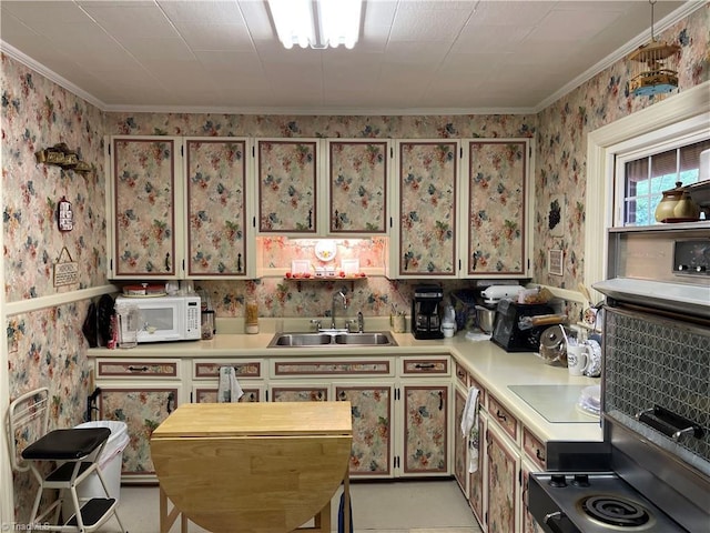 200 Trail Two, Burlington, NC 27215 - kitchen featuring white microwave, light countertops, wallpapered walls, ornamental molding, and cooktop