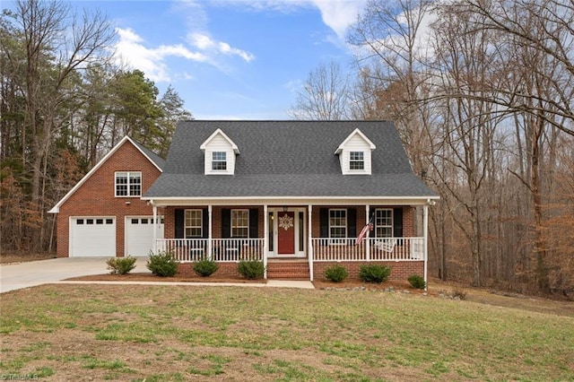 cape cod home with brick siding, a front lawn, concrete driveway, roof with shingles, and covered porch