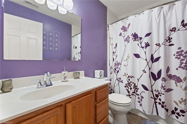 bathroom featuring tile patterned floors, visible vents, shower / bath combo with shower curtain, toilet, and vanity