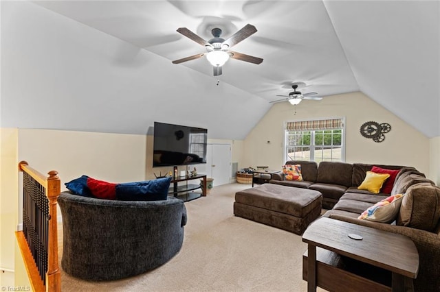 carpeted living room with ceiling fan and vaulted ceiling