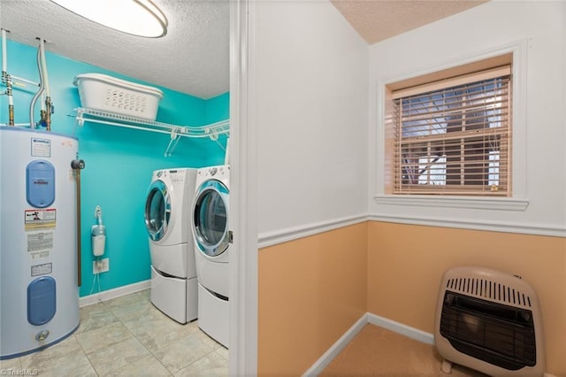 washroom with washer and dryer, heating unit, a textured ceiling, water heater, and laundry area