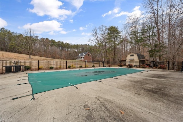 view of swimming pool featuring a patio area, a fenced in pool, and fence