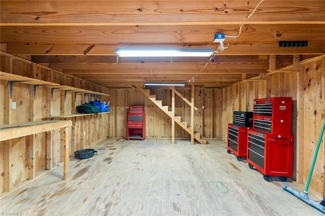 interior space featuring wood walls and stairs