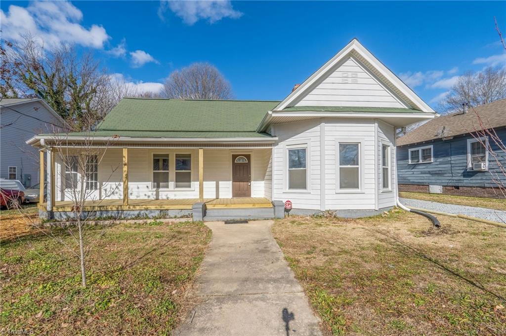 view of front of home with a front yard and a porch