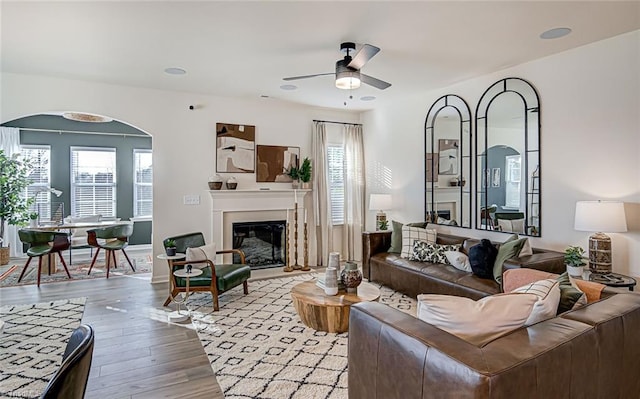 407 Brooke Hill Dr, Lewisville, NC 27023 - living room featuring a ceiling fan, wood finished floors, and a glass covered fireplace