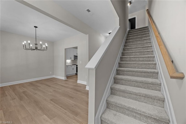 1337 Union Cross Rd, Kernersville, NC 27284 - staircase with a chandelier and wood finished floors
