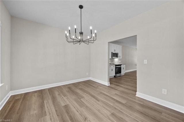 1337 Union Cross Rd, Kernersville, NC 27284 - unfurnished dining area with a chandelier and light wood-style floors