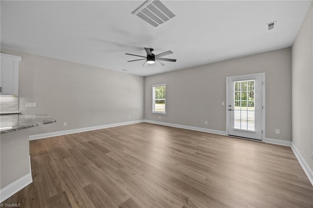 1337 Union Cross Rd, Kernersville, NC 27284 - unfurnished living room featuring healthy amount of natural light, wood finished floors, and a ceiling fan