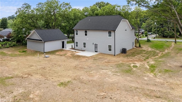 1337 Union Cross Rd, Kernersville, NC 27284 - back of house with a patio area, view of wooded area, roof with shingles, and an outdoor structure