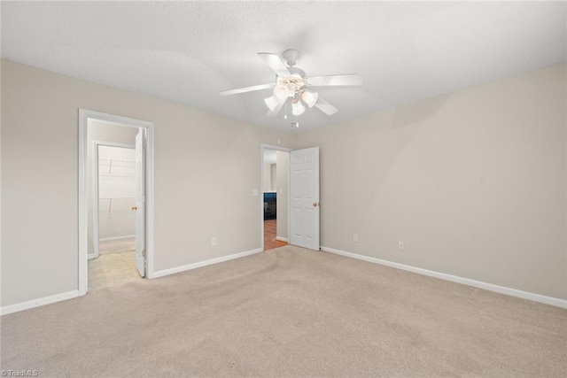 unfurnished room with light colored carpet and ceiling fan