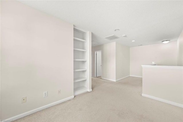 unfurnished room with light carpet