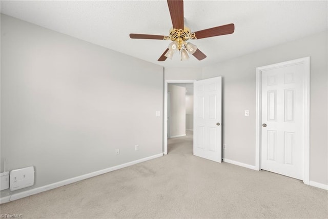 unfurnished bedroom featuring light colored carpet and ceiling fan