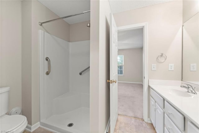 bathroom featuring vanity, a textured ceiling, walk in shower, and toilet