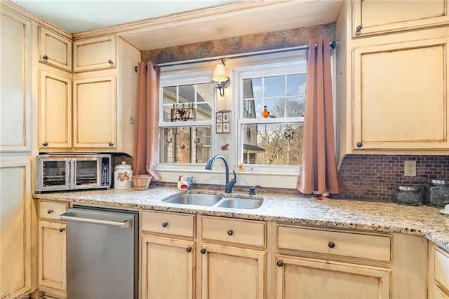 kitchen with stainless steel dishwasher, decorative backsplash, sink, and light brown cabinets