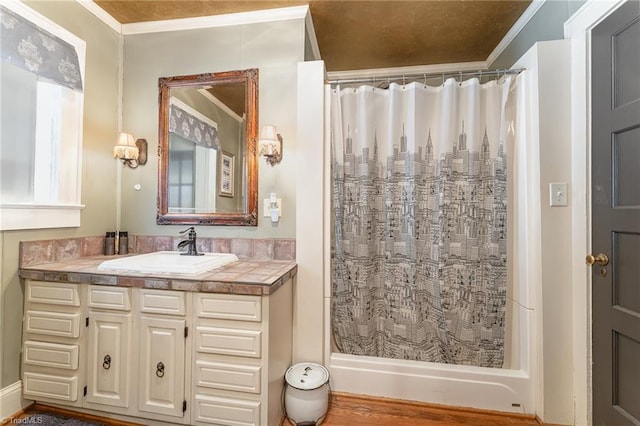 bathroom with crown molding, curtained shower, and vanity