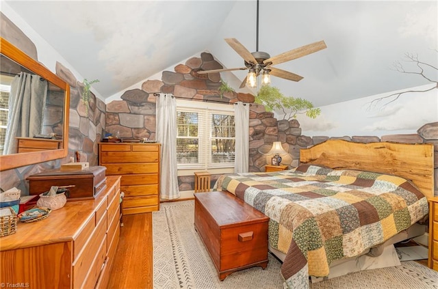 bedroom with ceiling fan, light hardwood / wood-style flooring, and lofted ceiling